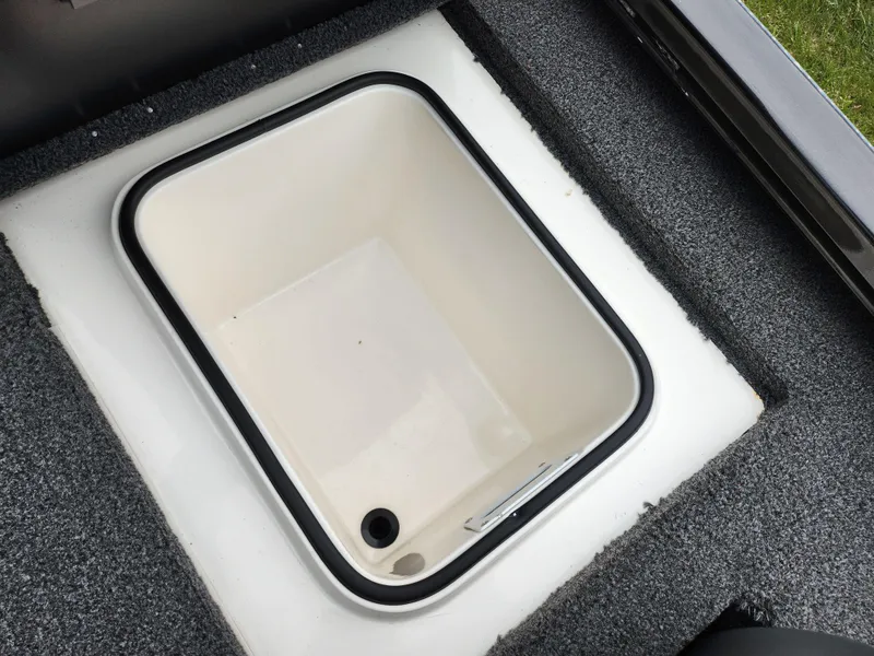 Slide: The Image of 2021 Vexus AVX189 boat storage compartment with white interior and black trim. - 24