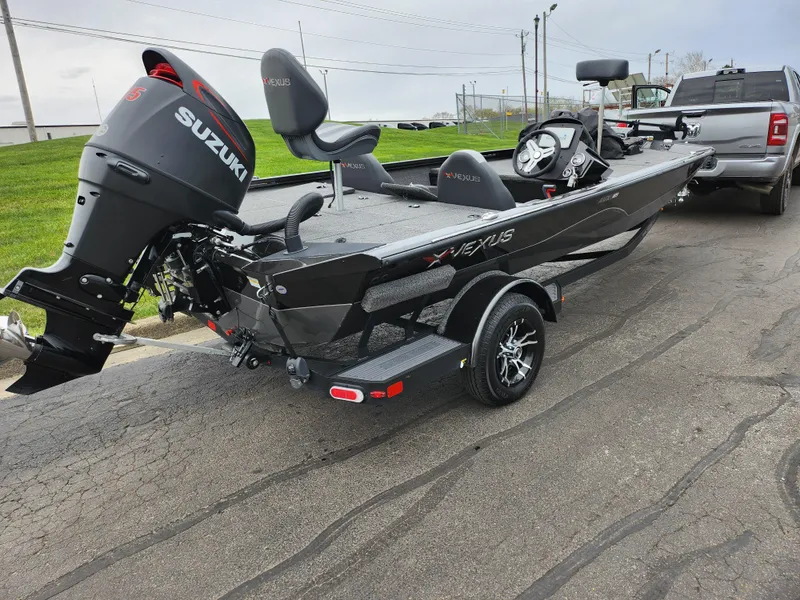 Slide: The Image of 2021 Vexus AVX189 boat with Suzuki engine, parked on a trailer. - 3