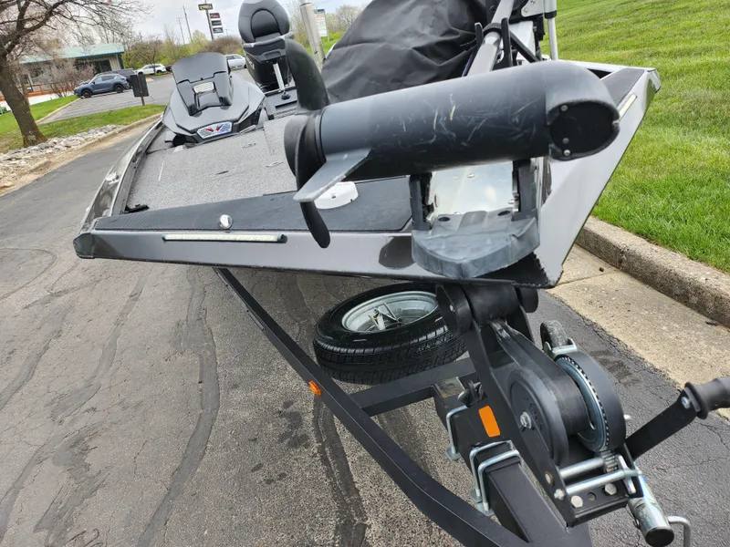 Slide: The Image of 2021 Vexus AVX189 boat on trailer, parked on a paved road near grass. - 6