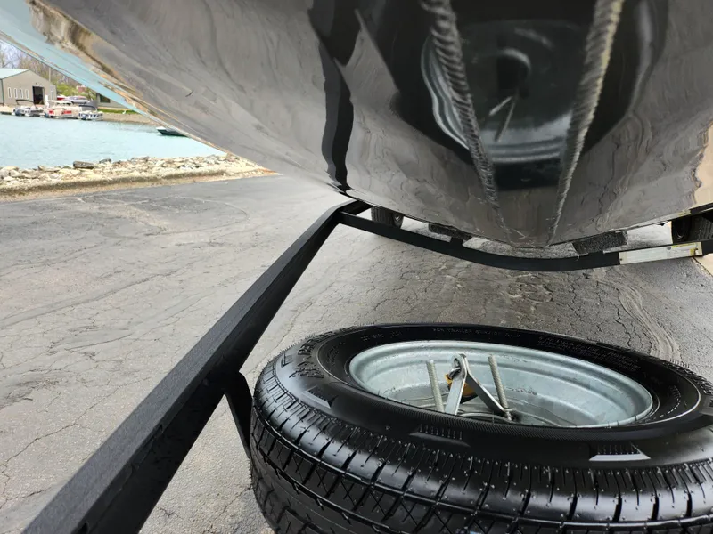 Slide: The Image of 2021 Vexus AVX189 boat on trailer with spare tire, near waterfront. - 7