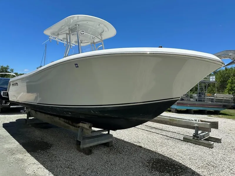 The Image of 2018 Release 232 RX Center Console boat on trailer under clear blue sky. - 0