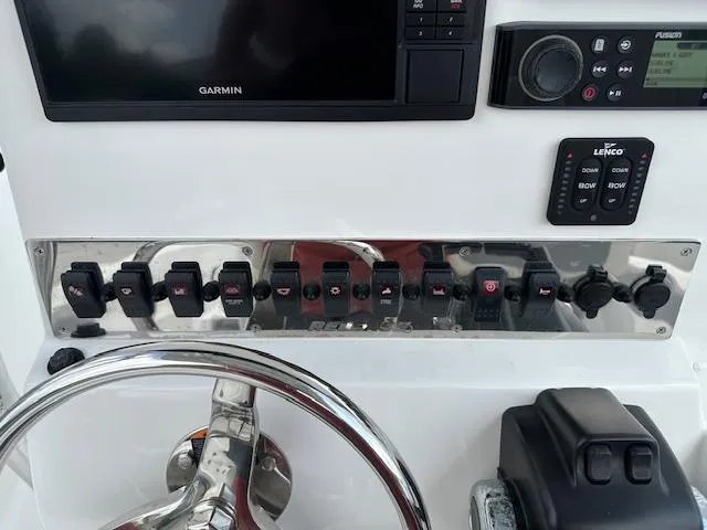 Slide: The Image of Control panel of 2018 Release 232 RX Center Console boat with Garmin display and switches. - 12
