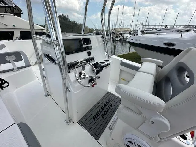 Slide: The Image of 2018 Release 232 RX Center Console boat interior with steering wheel and control panel. - 21