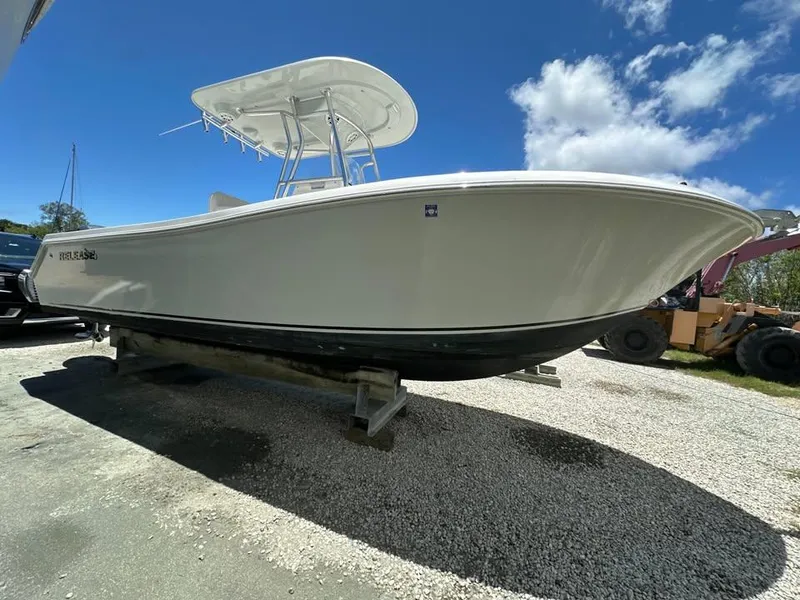 Slide: The Image of 2018 Release 232 RX Center Console boat on display under clear blue sky. - 4