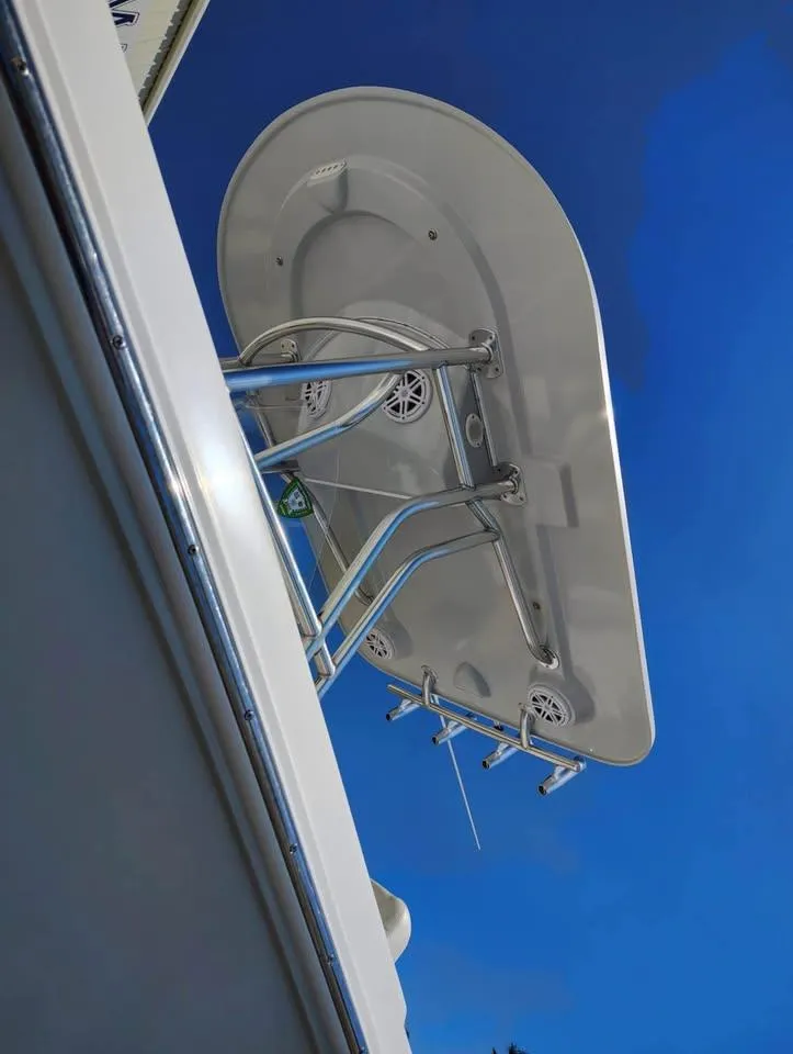 Slide: The Image of 2018 Release 232 RX Center Console boat with T-top against clear blue sky. - 6