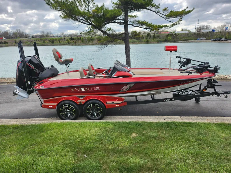 Slide: The Image of 2020 Vexus VX20 red boat on trailer by a lake, under cloudy sky. - 10