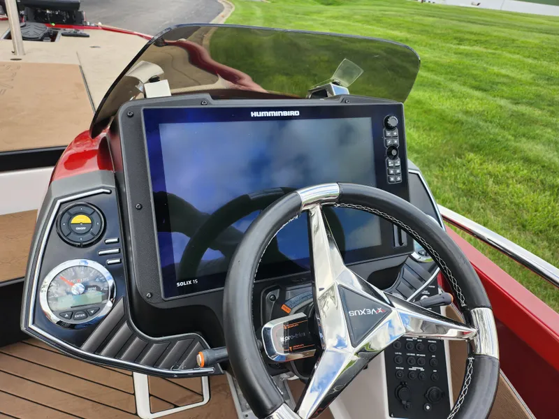 Slide: The Image of 2020 Vexus VX20 boat dashboard with Humminbird display and steering wheel. - 13