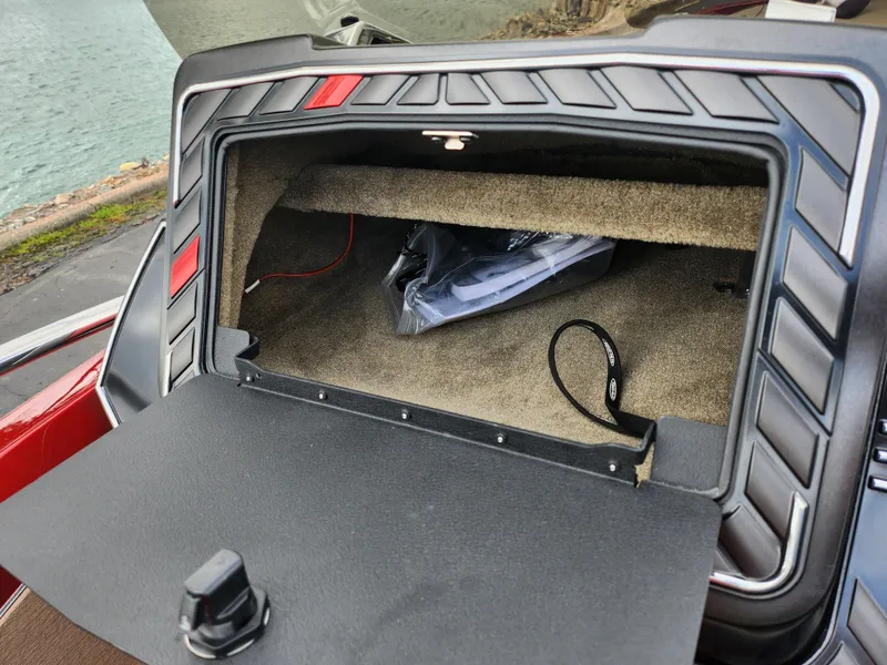 Slide: The Image of Open storage compartment in a 2020 Vexus VX20 boat, near a waterfront. - 14