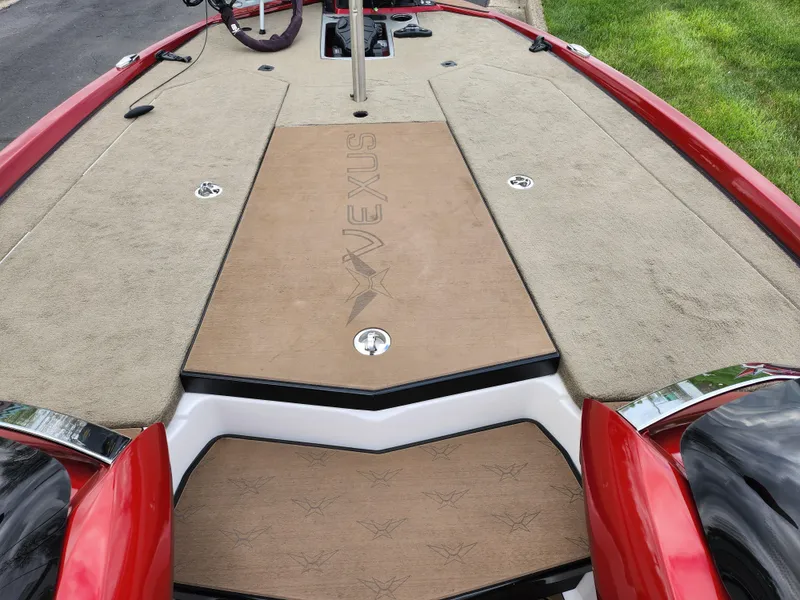 Slide: The Image of 2020 Vexus VX20 boat deck with red trim and beige carpeting. - 15
