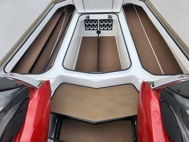 Slide: The Image of 2020 Vexus VX20 boat interior with red accents and storage compartments. - 16