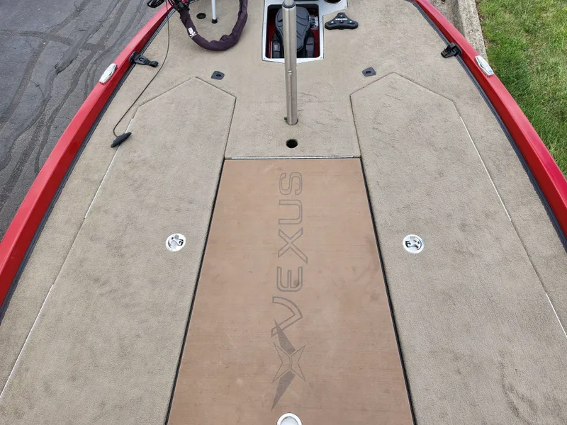 Slide: The Image of 2020 Vexus VX20 boat deck with tan carpeting and red trim. - 17
