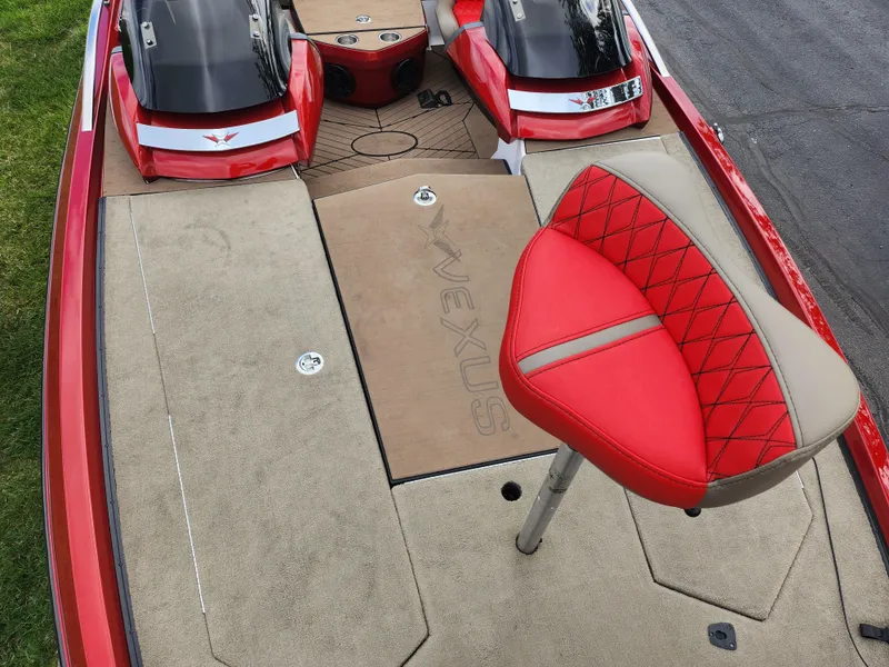 Slide: The Image of 2020 Vexus VX20 boat interior with red and beige seating, showcasing spacious deck design. - 20