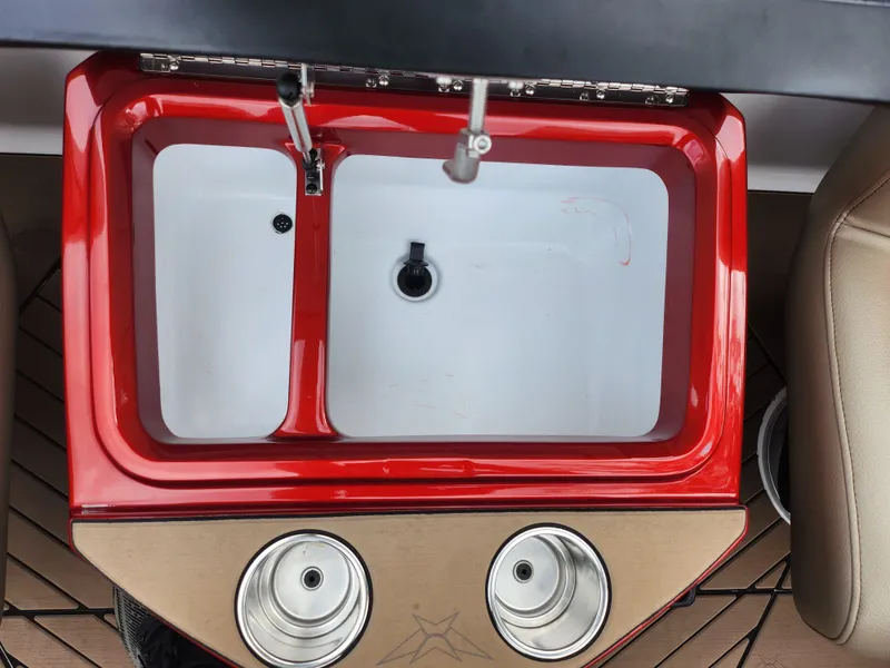 Slide: The Image of 2020 Vexus VX20 boat sink with red trim and dual cup holders. - 23
