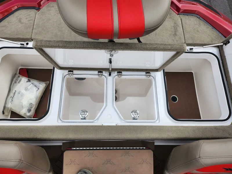 Slide: The Image of 2020 Vexus VX20 boat storage compartments with red and beige seating. - 25
