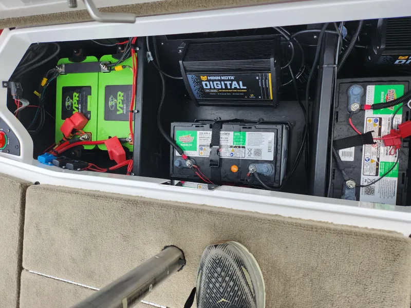 Slide: The Image of Battery compartment of a 2020 Vexus VX20 boat with multiple batteries and wiring. - 26