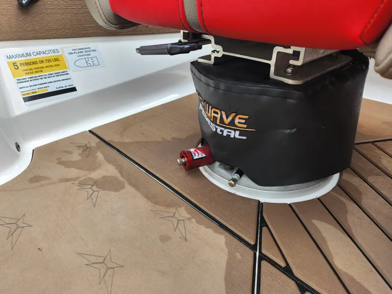 Slide: The Image of 2020 Vexus VX20 boat interior with red seat and Wave decal on brown flooring. - 27