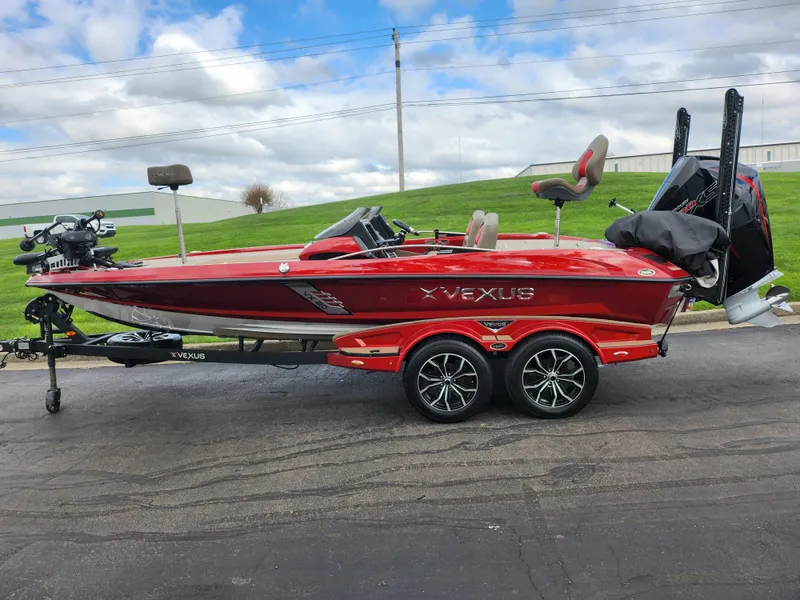 Slide: The Image of 2020 Vexus VX20 red fishing boat on trailer, parked outdoors under cloudy sky. - 4
