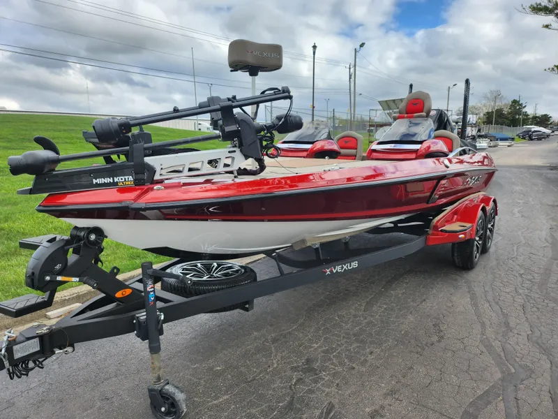 Slide: The Image of 2020 Vexus VX20 boat with red and white design on a trailer, parked outdoors. - 5