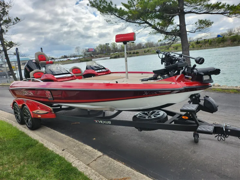 Slide: The Image of 2020 Vexus VX20 boat on trailer by a lakeside road, under cloudy sky. - 9