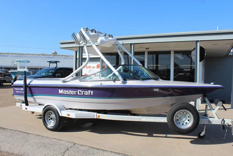 Slide: The Image of 1994 MasterCraft 190 Pro Star boat on trailer, parked outside a building. - 1