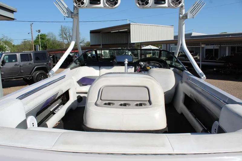 Slide: The Image of 1994 MasterCraft 190 Pro Star boat interior with seating and speakers, parked outdoors. - 11