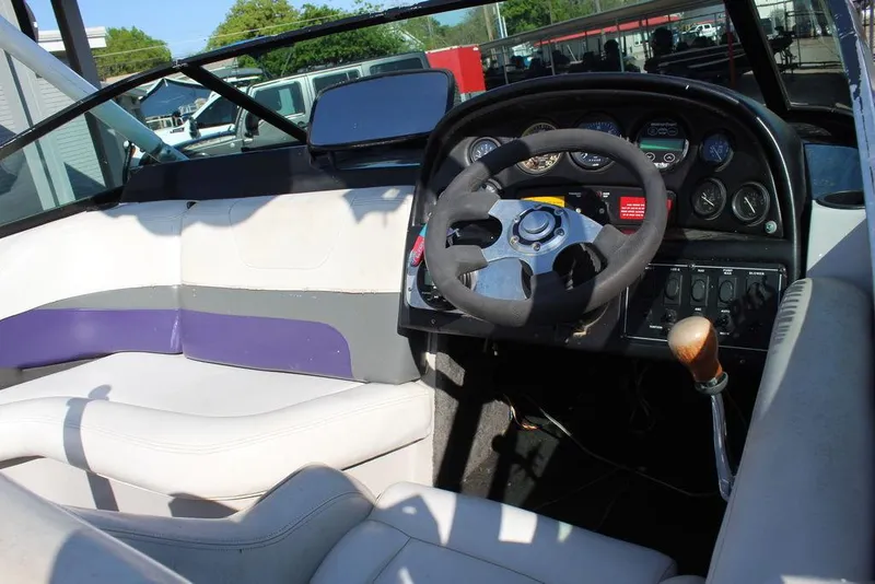 Slide: The Image of 1994 MasterCraft 190 Pro Star boat interior with steering wheel and dashboard controls. - 13