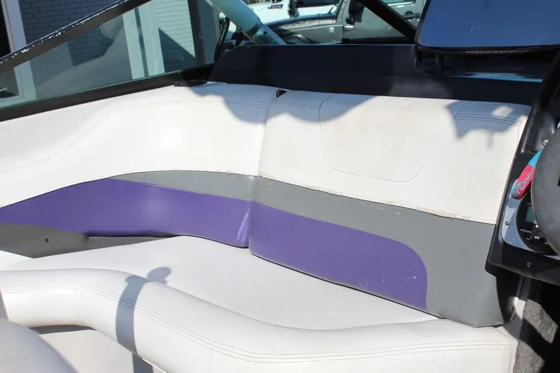 Slide: The Image of 1994 MasterCraft 190 Pro Star interior with white, purple, and gray seating. - 15