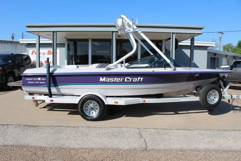 Slide: The Image of 1994 MasterCraft 190 Pro Star boat on trailer, parked outside a building. - 2