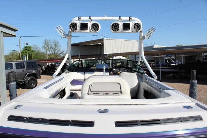 Slide: The Image of 1994 MasterCraft 190 Pro Star boat with tower speakers, parked outdoors. - 9