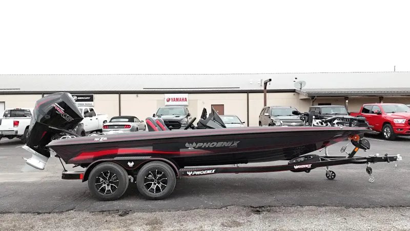 Slide: The Image of 2025 Phoenix 721 ZXL bass boat with trailer, parked outside dealership. - 1