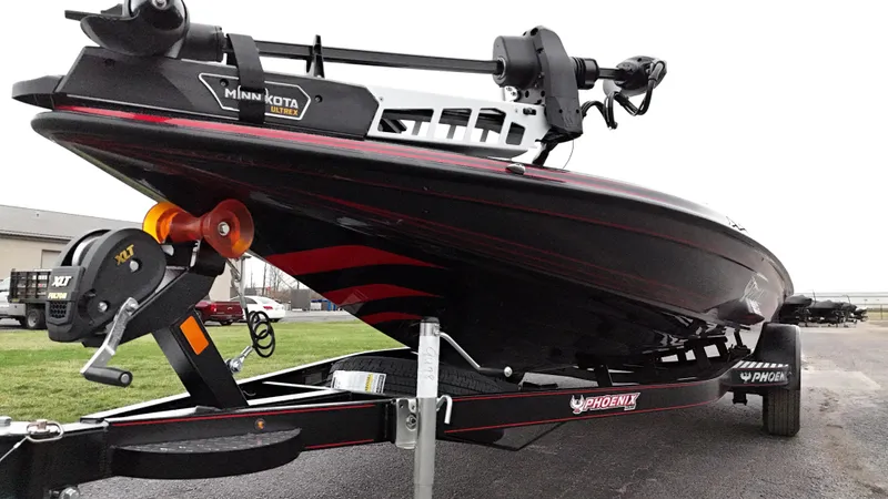 Slide: The Image of 2025 Phoenix 721 ZXL boat on trailer, featuring sleek black and red design. - 11