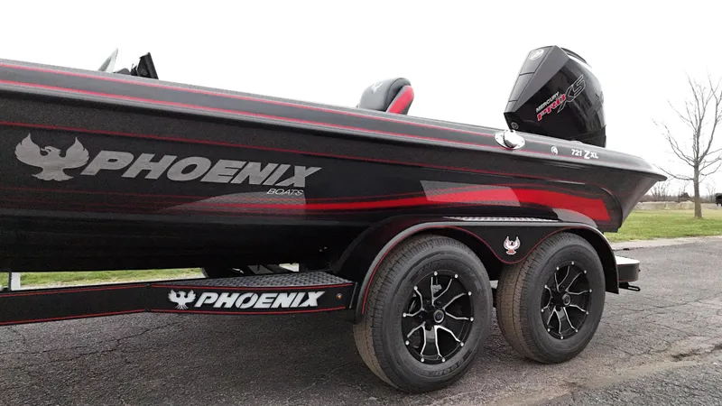 Slide: The Image of 2025 Phoenix 721 ZXL boat with sleek design and dual axle trailer. - 12