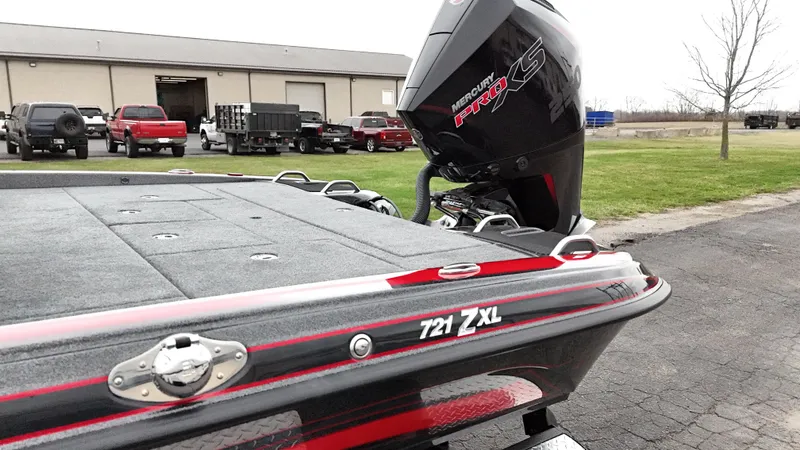 Slide: The Image of 2025 Phoenix 721 ZXL boat with powerful engine, parked outdoors near industrial building. - 13