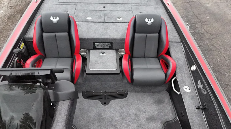 Slide: The Image of 2025 Phoenix 721 ZXL boat interior with two black and red seats, cup holders, and storage. - 18