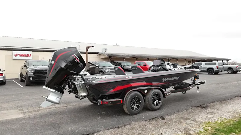 Slide: The Image of 2025 Phoenix 721 ZXL boat with Yamaha engine parked outside dealership. - 2