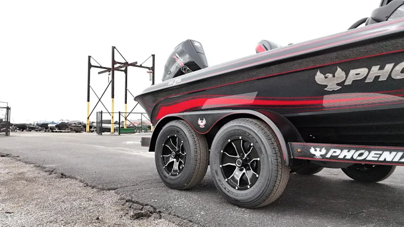 Slide: The Image of 2025 Phoenix 721 ZXL boat on trailer, showcasing sleek design and dual wheels. - 20