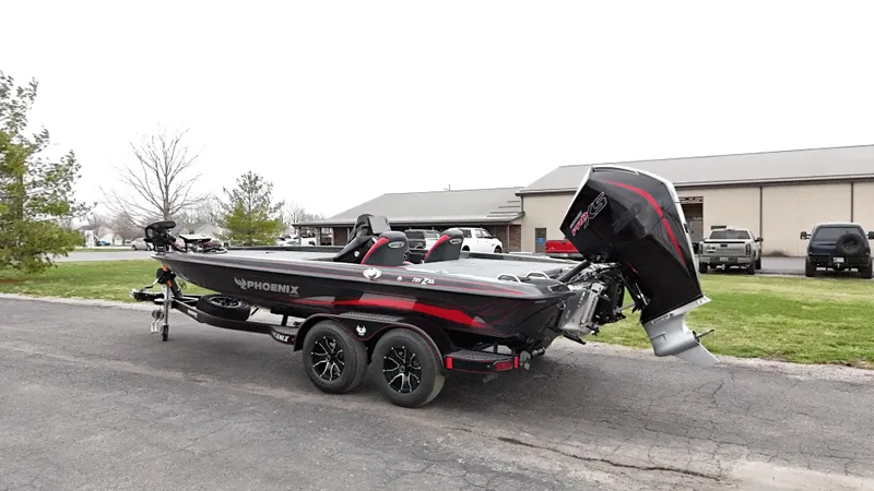 Slide: The Image of 2025 Phoenix 721 ZXL boat on trailer, parked outdoors, showcasing sleek design and powerful engine. - 4