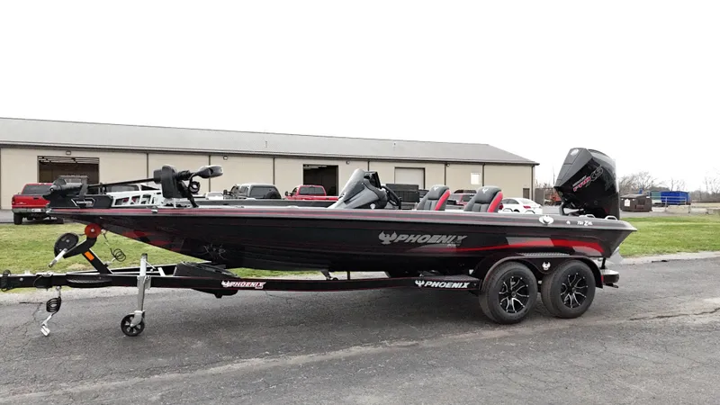 Slide: The Image of 2025 Phoenix 721 ZXL bass boat on trailer, parked outdoors. - 6