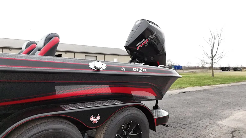 Slide: The Image of 2025 Phoenix 721 ZXL boat with sleek design and powerful engine, parked outdoors. - 7