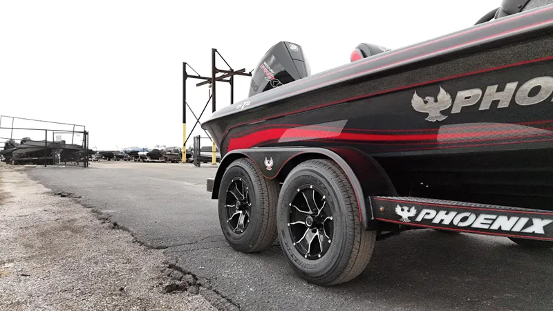Slide: The Image of 2025 Phoenix 721 ZXL boat on trailer, featuring sleek design and dual wheels. - 9