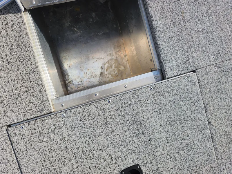 Slide: The Image of 2022 Tracker Pro 170 boat storage compartment with textured flooring. - 17