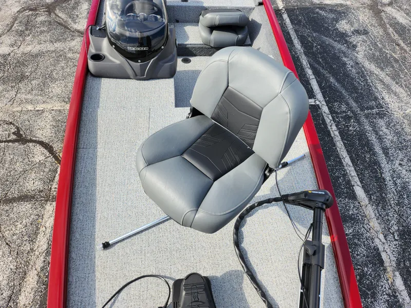 Slide: The Image of 2022 Tracker Pro 170 boat interior with gray seating and red trim. - 19