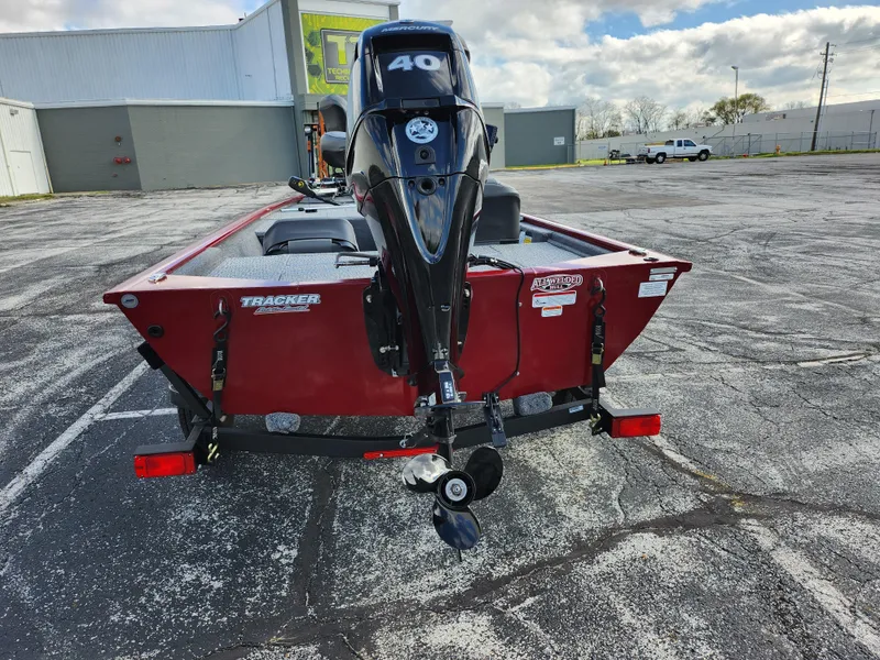 Slide: The Image of 2022 Tracker Pro 170 boat with a 40 HP engine, parked in an outdoor lot. - 2