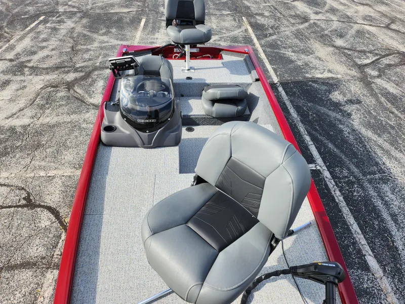 Slide: The Image of 2022 Tracker Pro 170 boat with gray seating and red trim, parked on asphalt. - 20