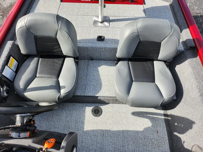 Slide: The Image of 2022 Tracker Pro 170 boat interior with two gray seats and steering wheel. - 22