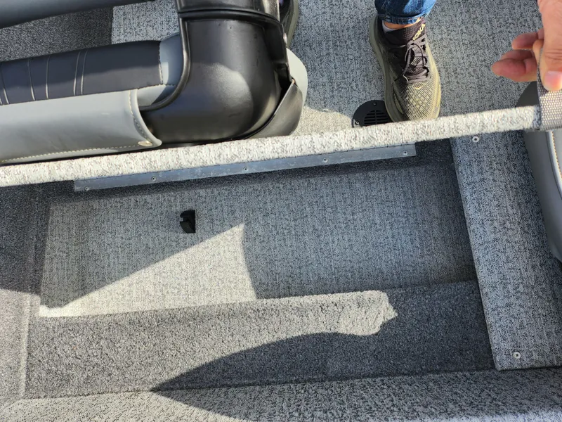 Slide: The Image of 2022 Tracker Pro 170 boat interior with gray carpet and seating detail. - 23