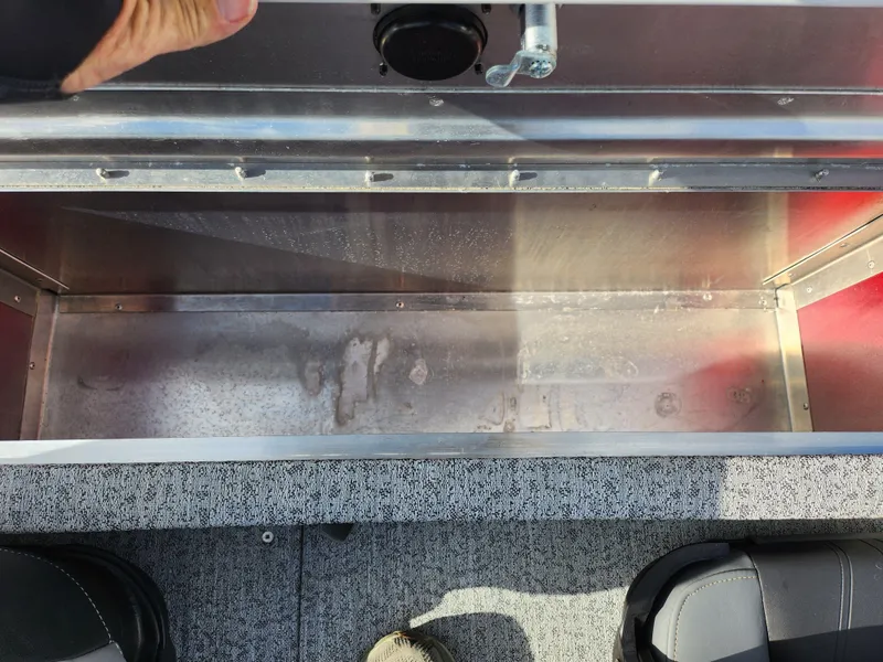 Slide: The Image of 2022 Tracker Pro 170 boat storage compartment with open lid, showing interior space. - 25