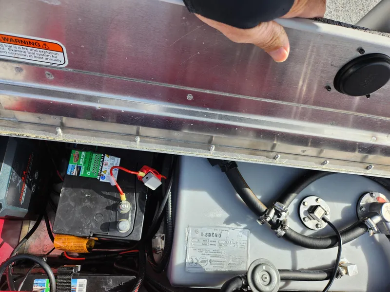Slide: The Image of 2022 Tracker Pro 170 boat battery and fuel system components under open hatch. - 26