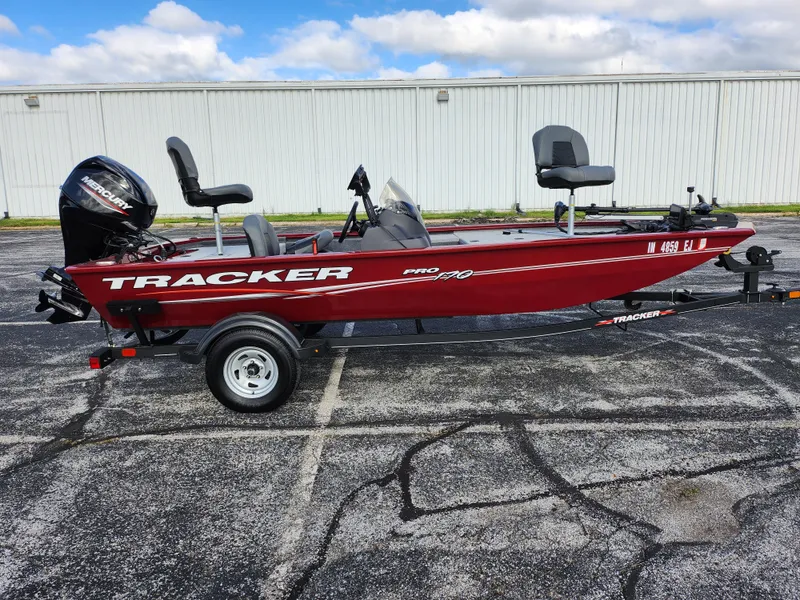 Slide: The Image of 2022 Tracker Pro 170 boat on trailer, red color, parked outdoors. - 4