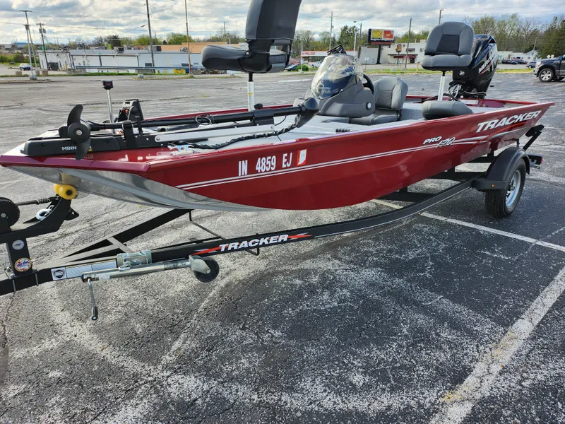 Slide: The Image of 2022 Tracker Pro 170 boat in parking lot, red exterior, on trailer. - 9